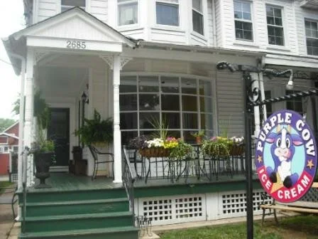 front porch view of purple cow main street